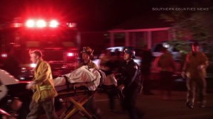 One victim was taken by stretcher to an ambulance after being shot in Long Beach. (Credit: Southern Counties News) 