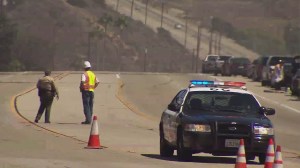 A fire was believed to have caused a downed power line in Malibu that led to a street closure between Latigo Canyon Road and John Tyler Drive on Sept. 6, 2014. (Credit: KTLA)