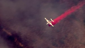 A fixed-wing aircraft drops retardant on the Silverado Fire on Sept. 12, 2014. (Credit: KTLA)