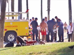 A photo taken at Venice Beach on Sept. 15, 2014, shows first responders treating a woman injured when she was run over by a lifeguard vehicle. (Credit: NameOnRice)