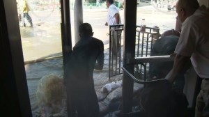 Locals could be seen sandbagging businesses in West Hollywood after a water main break on Sept. 26, 2014. (Credit: KTLA)