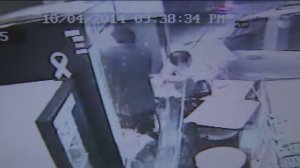 Surveillance video showed a man getting hit by an SUV that crashed through a doughnut shop on Oct. 4, 2014. The man was OK. 