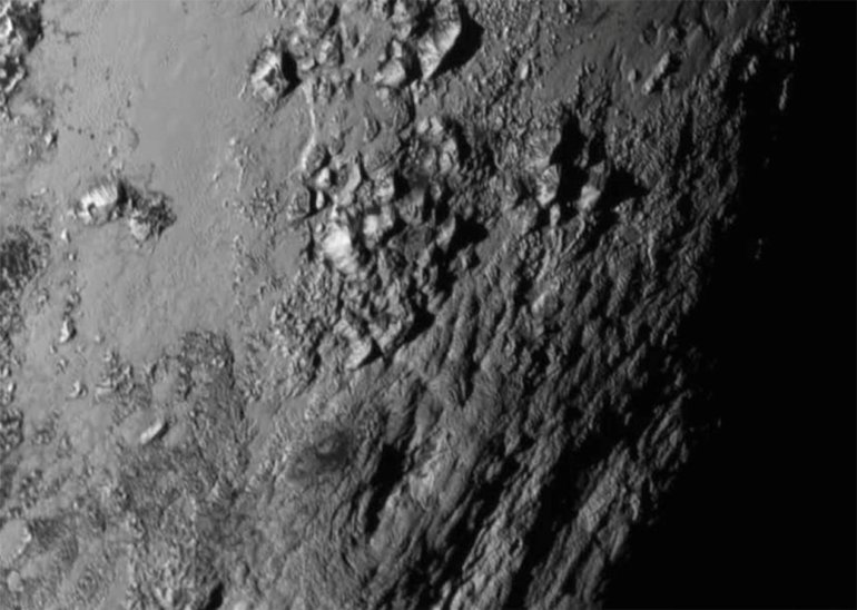 NASA releases a new image of Pluto showing mountans near the equator.