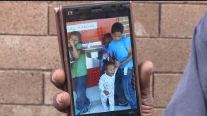 Earl Lampley, grandfather to Javion Johnson, holds up a picture of the 23-month-old who died this morning. 