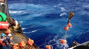 Hauling up hydrophone during the Challenger Deep mission in 2015. (NOAA)