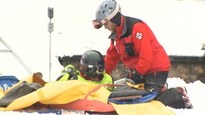 Steamboat ski patrol team members assists an injured skier