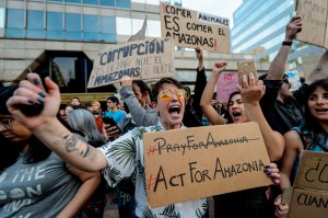 Activists demonstrate during a protest against the government of Brazil's President Jair Bolsonaro over the fires in the Amazon rainforest in front of Brazil's Embassy in Santiago on August 23, 2019. - Bolsonaro said Friday he is considering deploying the army to help combat fires raging in the Amazon rainforest, after news about the fires have sparked protests around the world. The latest official figures show 76,720 forest fires were recorded in Brazil so far this year -- the highest number for any year since 2013. More than half are in the Amazon. (Photo by MARTIN BERNETTI / AFP) (Photo credit should read MARTIN BERNETTI/AFP/Getty Images)