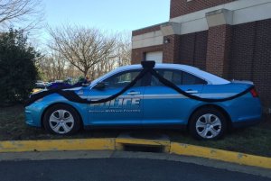 The Prince William (VA) Police Department cloaked one of its cruisers in a black cloth to honor Officer Ashley Guindon who died in a shooting Saturday.