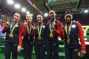 RIO DE JANEIRO, BRAZIL - AUGUST 09: (L to R) Gold medalists Alexandra Raisman, Madison Kocian, Lauren Hernandez, Gabrielle Douglas and Simone Biles of the United States pose for photographs with their medals after the medal ceremony for the Artistic Gymnastics Women's Team on Day 4 of the Rio 2016 Olympic Games at the Rio Olympic Arena on August 9, 2016 in Rio de Janeiro, Brazil. (Photo by Laurence Griffiths/Getty Images)