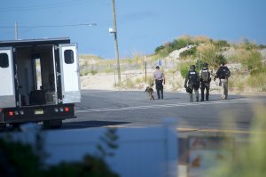 Police officers patrol near the scene of an "pipe bomb-style device" explosion on September 17, 2016 in Seaside Park, New Jersey. The explosive device detonated in a trash can after 9:30am this morning along the route of the Seaside Semper Five Marine Corps Charity 5K run to benefit military soldiers. No injuries were reported. (Photo by Mark Makela/Getty Images)