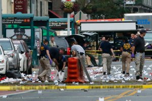 Law Enforcement Officers are seen at the scene of an explosion on West 23rd Street September, 18, 2016 in New York. An explosion rocked one of the most fashionable neighborhoods of New York on September 17 night, injuring 29 people, one seriously, a week after America's financial capital marked the 15th anniversary of the 9/11 attacks. Mayor Bill de Blasio indicated the blast was not accidental, even if there was no known link to terrorism. The blast occurred in Chelsea -- an area packed with bars, restaurants and luxury apartment blocks -- at a typically bustling time of the weekend /(Photo credit: KENA BETANCUR/AFP/Getty Images)