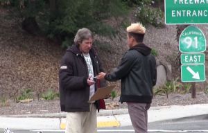 Josh Paler Lin gives a homeless man $100 in cash. Courtesy: Josh Paler Lin/YouTube