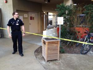 An officer stands guard near the roped-off emergency room.