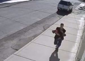 A man was seen on surveillance camera running with a toddler in his arms, he allegedly took the child from a stroller. 