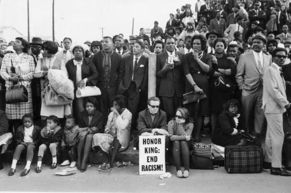 9th April 1968: Mourners waiting for Dr Martin Luther King's funeral cortege to pass them outside Moorhouse College in Atlanta, Georgia. (Photo by Keystone/Getty Images)