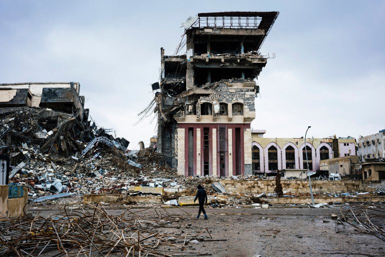An Iraqi man walks outside Mosul's University on January 22, 2017, a week after Iraqi counter-terrorism service (CTS) retook it from the Islamic State (IS) jihadists. Iraqi forces battled the last holdout jihadists in east Mosul after commanders declared victory there and quickly set their sights on the city's west, where more tough fighting awaits. (Photo credit: DIMITAR DILKOFF/AFP/Getty Images)