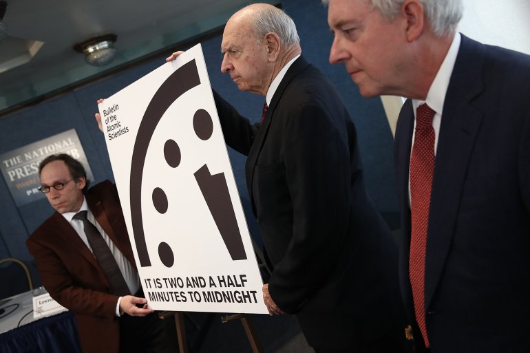 Members of the Bulletin of Atomic Scientists unveil the 2017 time for the "Doomsday Clock" January 26, 2017 in Washington, DC. For the first time in the 70-year history of the Doomsday Clock, the Bulletin of Atomic Scientists moved the clock forward 30 seconds to two and a half minutes before midnight, citing "ill-considered" statements by U.S. President Donald Trump on nuclear weapons and climate change, developments in Russia, North Korea, India and Pakistan. From left to right are theoretical physicist Lawrence Krauss, former U.S. Ambassador to the United Nations Thomas Pickering and retired U.S. Navy Rear Admiral David Titley. (Photo by Win McNamee/Getty Images)