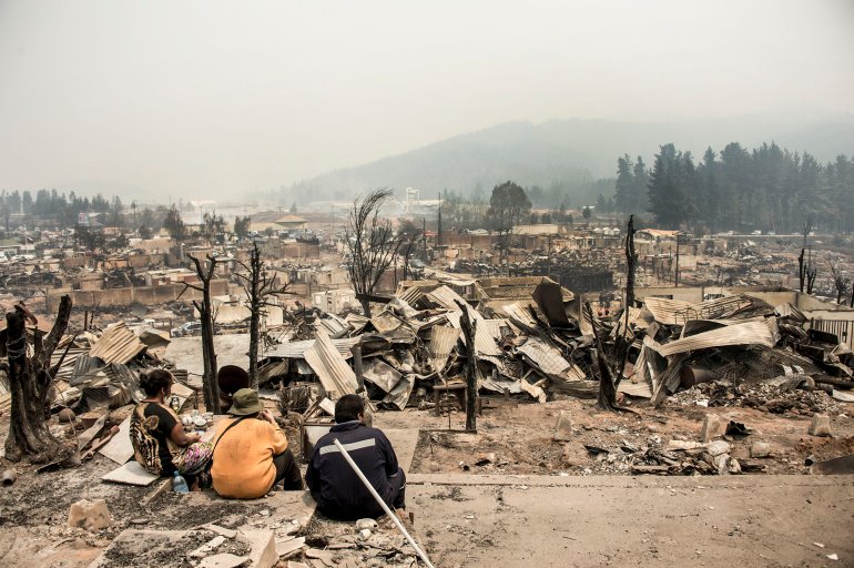 View of the remains of Santa Olga, 350 kilometres south of Santiago, after being devastated by a forest fire on January 27, 2017 Raging forest fires in central Chile have killed 10 people, displaced thousands and destroyed entire villages. Multiple blazes fueled by strong wind and drought conditions have ravaged 273,000 hectares (680,000 acres) in just over a week. / AFP / MARTIN BERNETTI (Photo credit should read MARTIN BERNETTI/AFP/Getty Images)