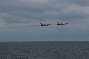The US military has released several photos of what it says were SU-24 Russian fighter jets "buzzing" the deck of a US warship in the Black Sea on February 10, 2017.