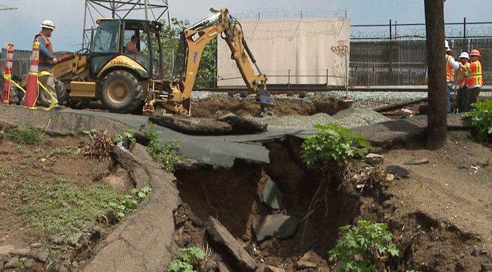 A sinkhole near trolley tracks in Barrio Logan caused delays in service July 20, 2015.