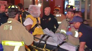 Medics take injured Uber driver away from Gaslamp Quarter crash in restraints after he "struggled" with an officer, San Diego police said. (Credit: SDNV.tv)