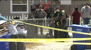 Investigators tape off road near AutoZone to investigate a shooting.