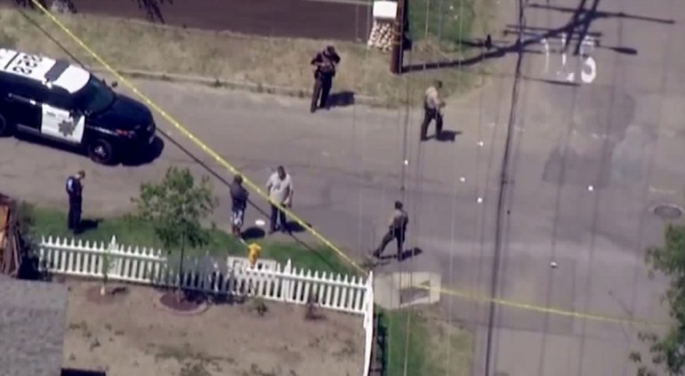 Investigators tape off road near AutoZone to investigate a shooting.