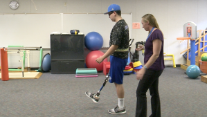 Giancarlo Gil is learning to walk again with help from therapist April Coyle.