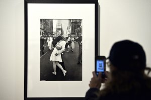 A visitor takes a snapshot of "VJ Day a Times Square, New York, NY, 1945" by Alfred Eisenstaedt during the 'Life. I grandi fotografi" (Life. The great photographers) exhibition at the auditorium on April 30, 2013 in Rome. The exhibition showing some 150 pictures taken from 1936 when the US magazine Life magazine premiered will be open from May, 1 to August 4, 2013. (Photo credit should read GABRIEL BOUYS/AFP/Getty Images)