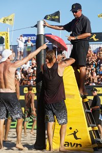 Jake Gibb and Casey Patterson discuss a call with referee Dan Apol during AVP competition. (Credit: Ed Chan)