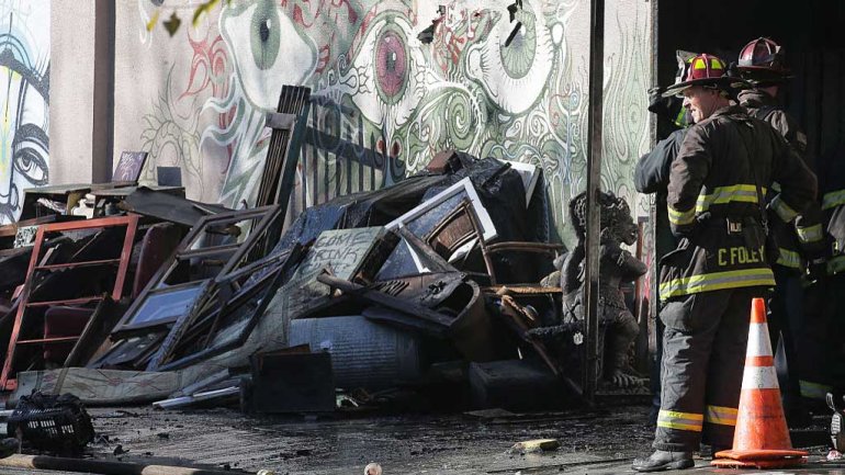 Firefighters work at the scene following an overnight fire that claimed the lives of 36 people at a warehouse in the Fruitvale neighborhood on December 3, 2016 in Oakland, California. Photo by Elijah Nouvelage/Getty Images)