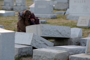 Melanie Steinhardt comforts Becca Richman at the Jewish Mount Carmel Cemetery in Philadelphia. Police say more than 100 tombstones were vandalized a week after a Jewish cemetery in St. Louis was desecrated. (Getty Images)