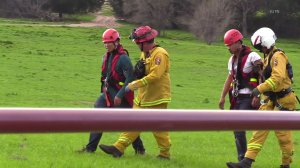CAL Fire crews walk alongside two men who survived a small plane crash near Ramona on Feb. 12, 2017. (911 VN)