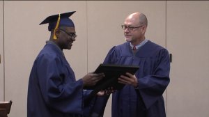 Maurice Jones receives his high school diploma at the Kansas City Rescue Mission.