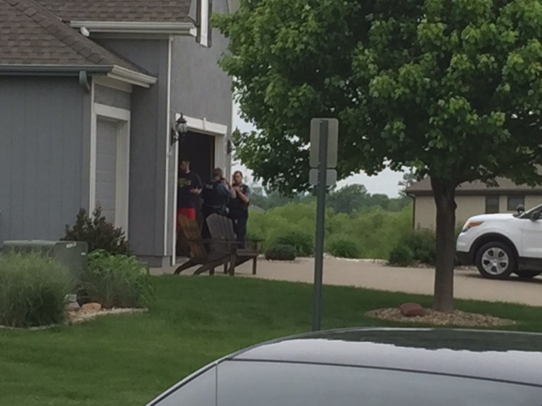 Multiple KCK detectives at a home in Basehor, Kan., Monday afternoon. Police reportedly found a vehicle that was possibly taken by the suspect in the detective's shooting. Basehor is approximately nine miles west of Kansas Speedway.