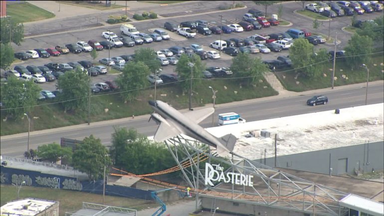 The standoff is south of the Roasterie, which you can spot thanks to the airplane prop.