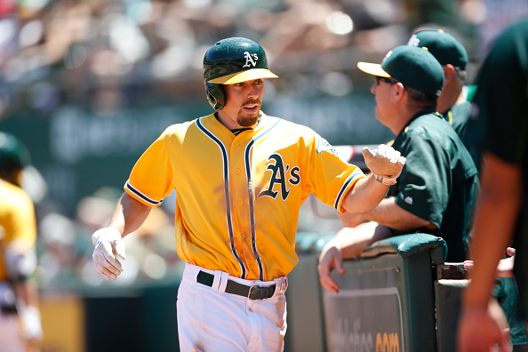OAKLAND, CA - JUNE 18: Billy Burns #1 of the Oakland Athletics is congratulated at the dugout during the game against the Los Angeles Angels of Anaheim at the Oakland Coliseum on June 18, 2016 in Oakland, California. The Angels defeated the Athletics 7-1. (Photo by Michael Zagaris/Oakland Athletics/Getty Images)