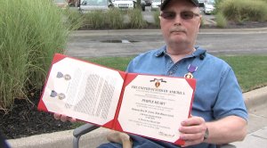 Fulton displays his Purple Heart
