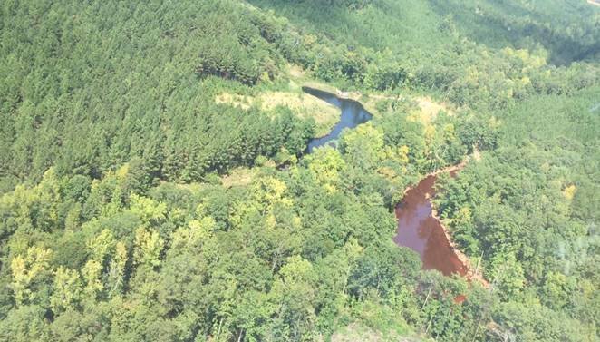 CNN has obtained photos of the oil spill in Shelby County, Alabama from the Colonial Pipeline Company based in Alpharetta, GA. In the aerial photos you can see a pond appearing to be full of gasoline, the pond has turned completely brown and according to Colonial Pipeline the oil is contained there. In the other photos you can see crews digging on a pipeline below the ground. Alabama and Georgia has declared a State of Emergency because of the oil spill.