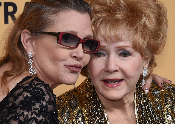 LOS ANGELES, CA - JANUARY 25: Actresses Debbie Reynolds (R), recipient of the Screen Actors Guild Life Achievement Award, and her daughter Carrie Fisher pose in the press room during the 21st Annual Screen Actors Guild Awards at The Shrine Auditorium on January 25, 2015 in Los Angeles, California. (Photo by Ethan Miller/Getty Images)