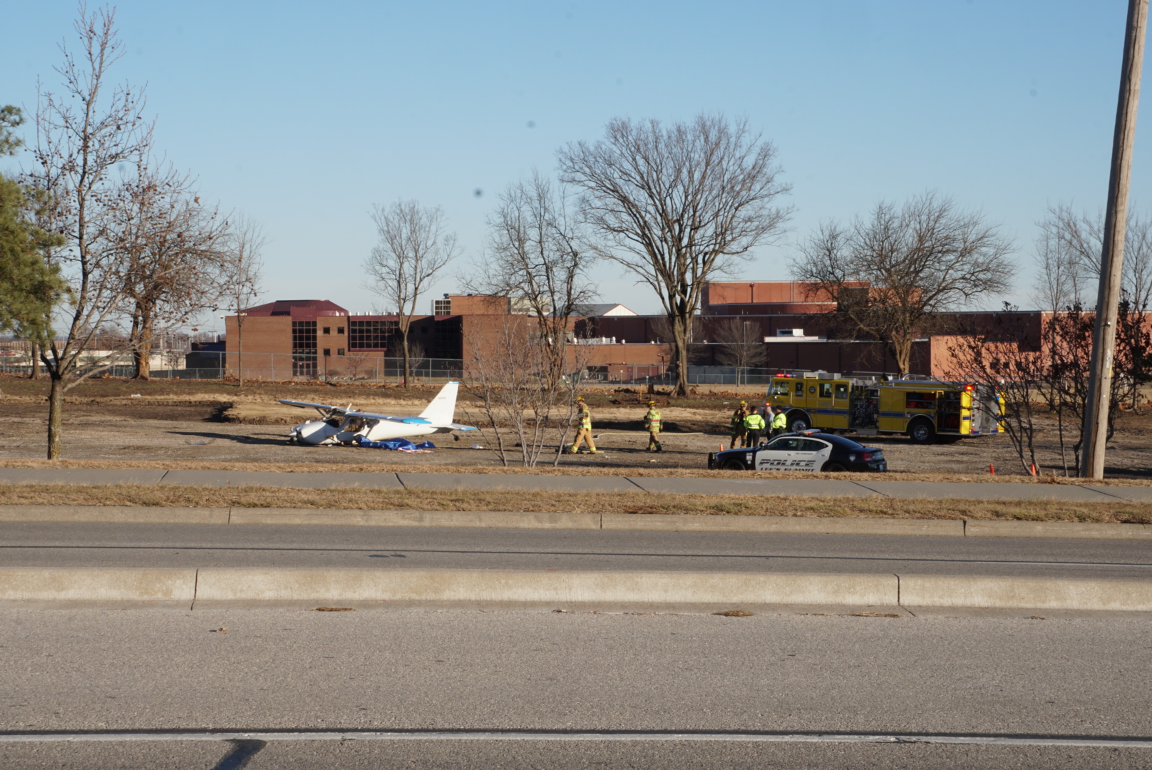 The plane came to rest near a parking lot of a park.