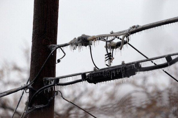 DALLAS, TX - DECEMBER 06: Icicles form on a power line on December 6, 2013 in Dallas, Texas. The ice storm that has hit North Texas has left over 250,000 residents and businesses without power and has led to more than 1,700 flight delays and cancellations across the country. (Photo by Ronald Martinez/Getty Images)