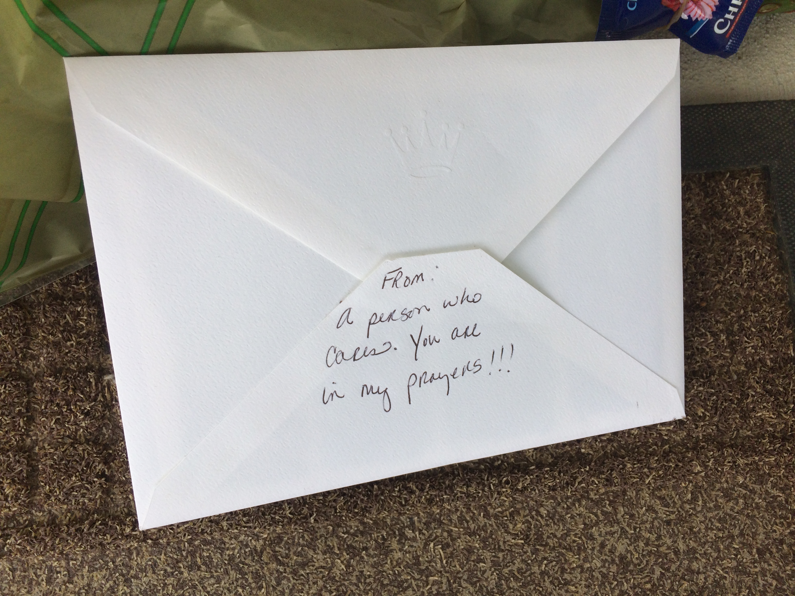 Flowers and a card inside of an envelope that says "From: A person who cares, you're in my prayers," was left on the porch of one of the shooting victims.