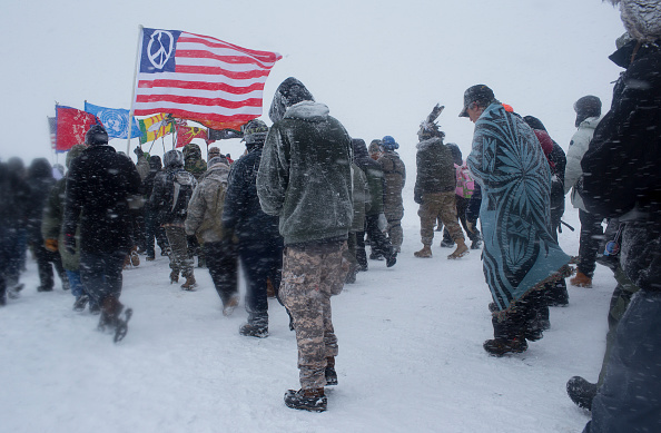 Dec. 5, 2016- On the day of a government order to vacate the area, hundreds of United States military veterans vowed to defend the Standing Rock protest camp. Over two hundred tribes, joined by environmental activists and hundreds of United States military veterans, camp and demonstrate against the Dakota Access Pipeline, which plans to be built under the Missouri River adjacent to the reservation. The gathering has been the largest meeting of Native Americans since the Little Bighorn camp in 1876. (Photo by Andrew Lichtenstein/Corbis via Getty Images)