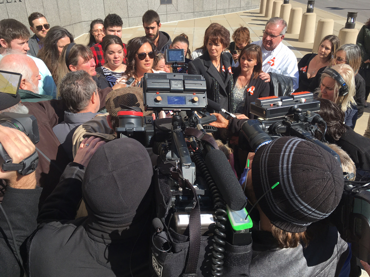 Sheppard's family is surrounded by cameras, as they react to the judge's decision.