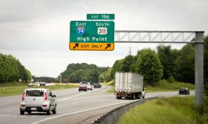 A new sign shows Interstate 74 and US 311 splitting off from Interstate 40 on the southeast side of Winston-Salem, even though that stretch of road doesn't meet federal guidelines to be called an interstate. (Andrew Dye/Journal)