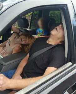The Liverpool Police Department posted shocking photos to Facebook showing two adults, who police believe were on heroin, passed out in a car with a little boy in the backseat. (Photo Credit: East Liverpool Police)