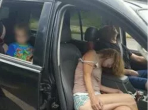 The Liverpool Police Department posted shocking photos to Facebook showing two adults, who police believe were on heroin, passed out in a car with a little boy in the backseat. (Photo Credit: East Liverpool Police)