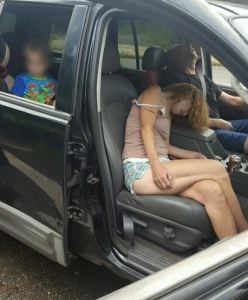 The Liverpool Police Department posted shocking photos to Facebook showing two adults, who police believe were on heroin, passed out in a car with a little boy in the backseat. (Photo Credit: East Liverpool Police)