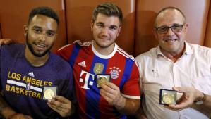 Anthony Sadler, from Pittsburg, California, Aleck Sharlatos from Roseburg, Oregon, and Chris Norman, a British man living in France (L-R), three men who helped to disarm an attacker on a train from Amsterdam to France, pose with medals they received for their bravery at a restaurant in Arras, France August 21, 2015. A machine gun-toting attacker wounded three people on a high-speed train in France on Friday before being overpowered by passengers who included an American soldier. The wounded were the soldier, French actor Jean-Hugues Anglade, and a Briton. Local media reported that U.S. Marines were among those who brought down the gunman. Officials said the attacker was arrested after the shooting when the Amsterdam to Paris train stopped at Arras station in northern France. REUTERS/Pascal Rossignol TPX IMAGES OF THE DAY